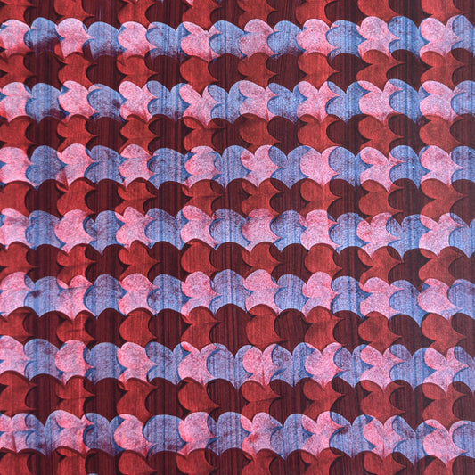 a sheet of wrapping paper with an abstract block print in dark red, pink and blue