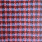 a sheet of wrapping paper with an abstract block print in dark red, pink and blue