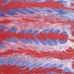 a sheet of wrapping paper with a marbled design in red, purple and white
