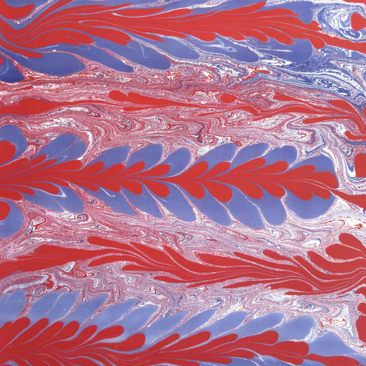 a sheet of wrapping paper with a marbled design in red, purple and white