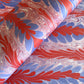 a sheet of wrapping paper with a marbled design in red, purple and white
