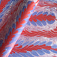 a sheet of wrapping paper with a marbled design in red, purple and white