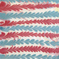 a sheet of wrapping paper with a marbled design in pink, blue and white