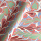 a sheet of wrapping paper with a marbled design in pink, blue, green and red