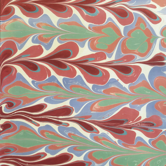 a sheet of wrapping paper with a marbled design in pink, blue, green and red