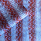 a sheet of wrapping paper with a paste paper style design in blue and dark red
