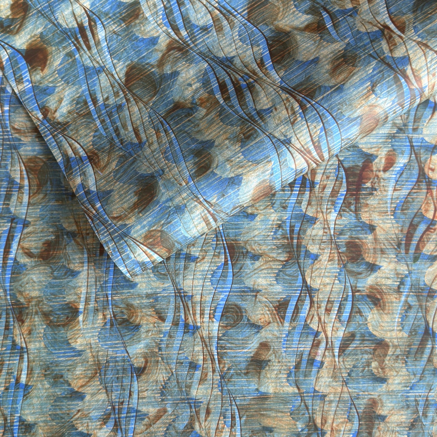 a sheet of wrapping paper with a paste paper style design in blue and brown