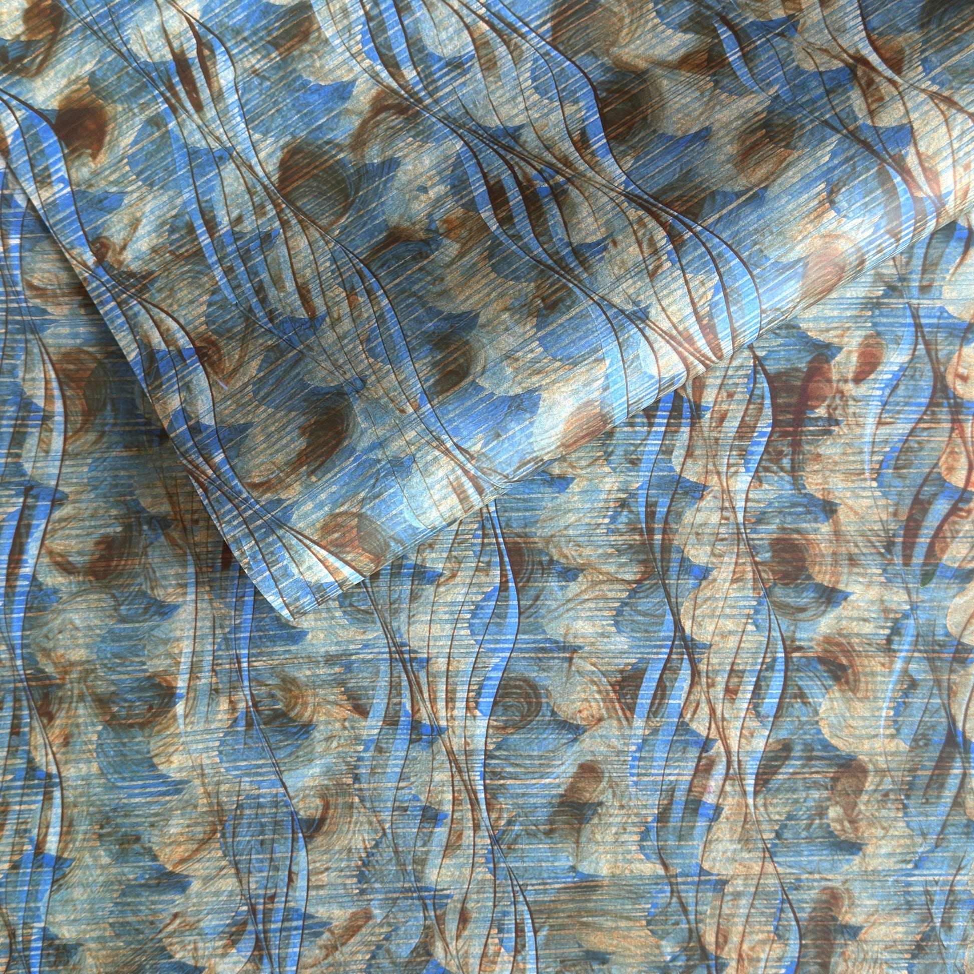 a sheet of wrapping paper with a paste paper style design in blue and brown
