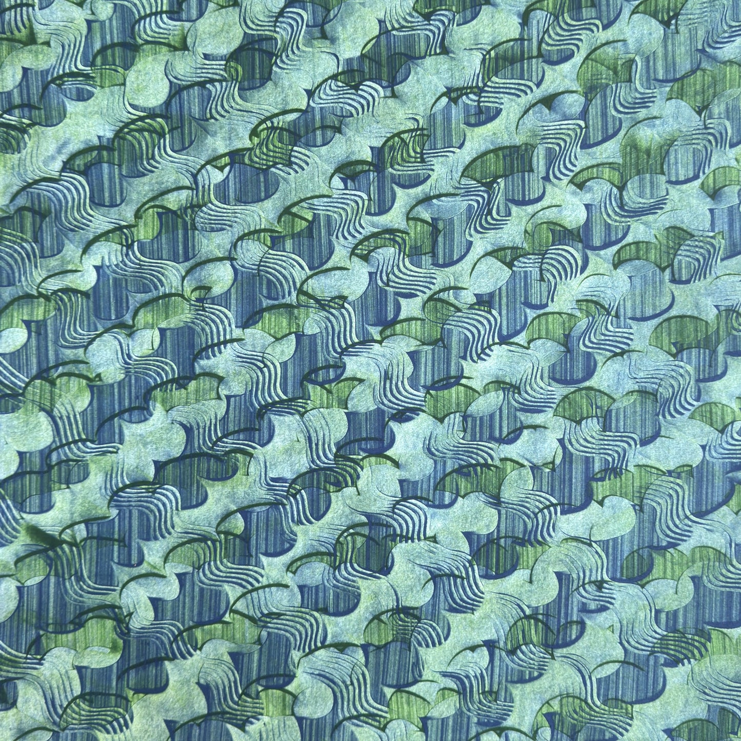 a sheet of wrapping paper with an abstract paste paper design in blue and green