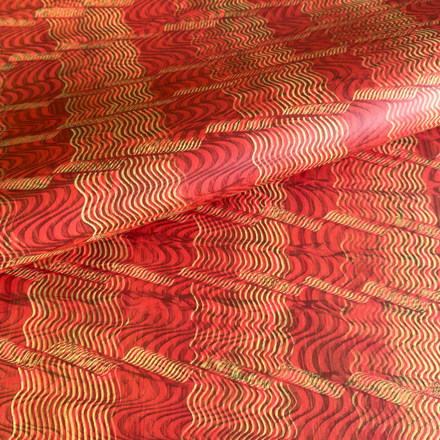 a sheet of wrapping paper with a paste paper style design in red and yellow