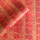 a sheet of wrapping paper with a paste paper style design in red and yellow