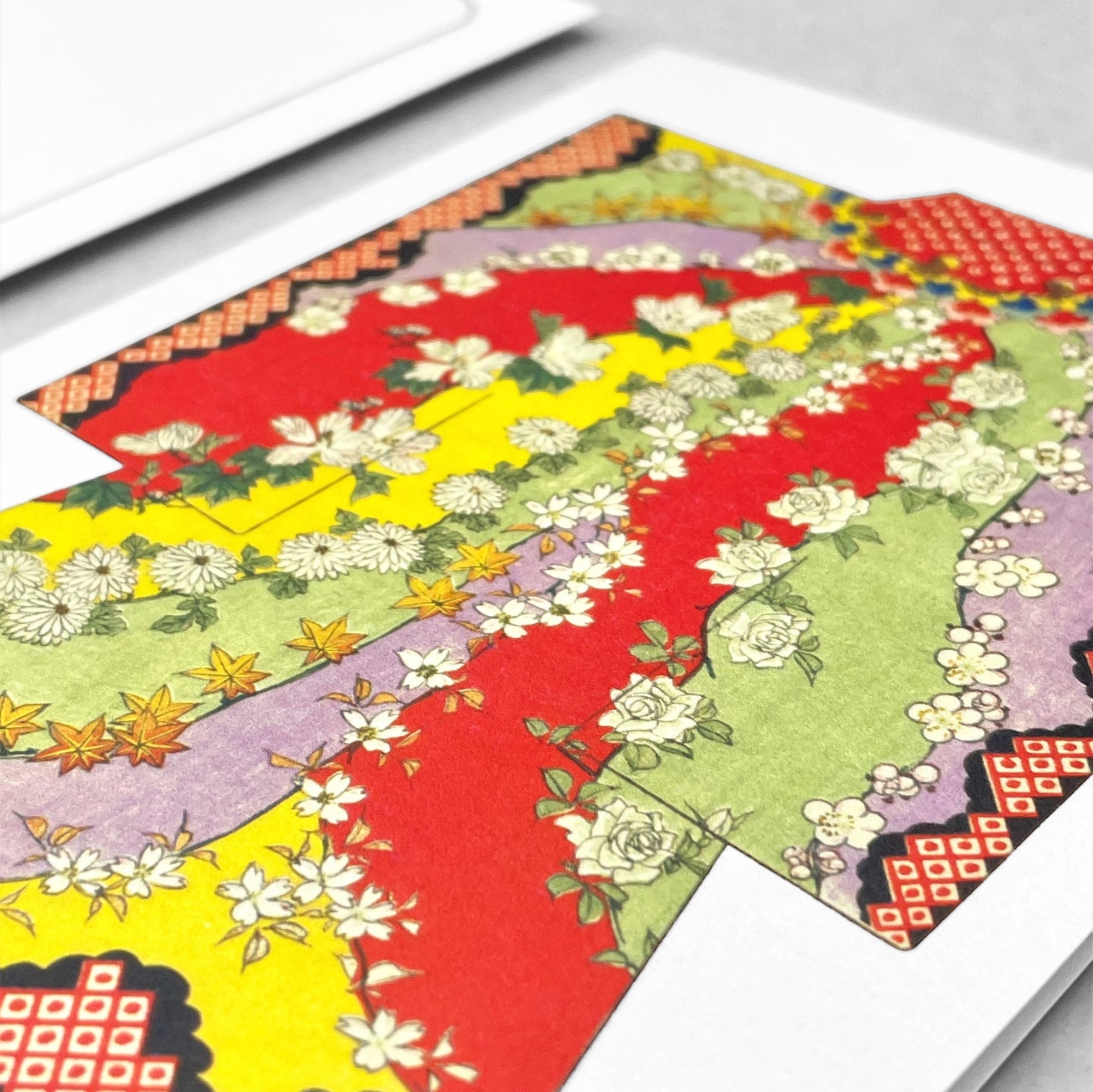 greetings card of a drawing of a bright floral kimono in red, yellow. green and lilac by Ezen Design