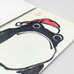 greetings card of a black japanese frog wearing a red santa hat by Ezen Design