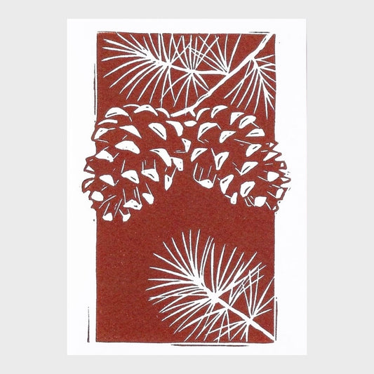 Greeting card with pine cone and branch design on a brown background