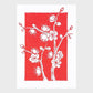 Greeting card with white floral plum blossom design on a red background