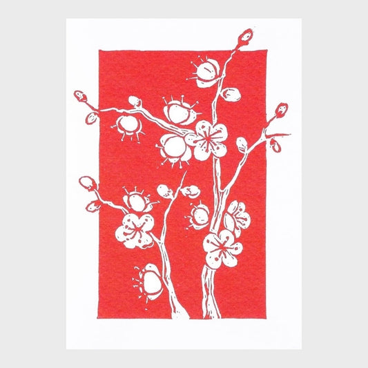 Greeting card with white floral plum blossom design on a red background