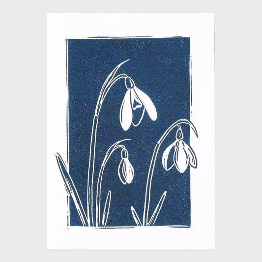 Greeting card with snowdrop design on a blue background,