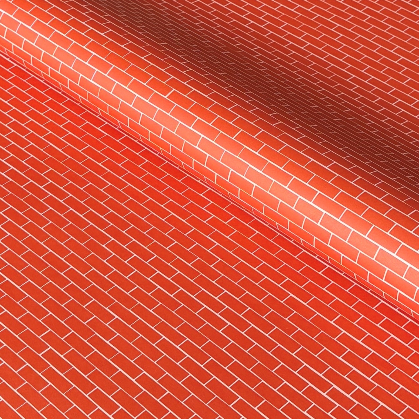 a sheet of gift wrap with a small brick design in rich red and pink