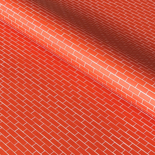 a sheet of gift wrap with a small brick design in rich red and pink