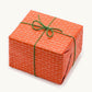 a sheet of gift wrap with a small brick design in rich red and pink