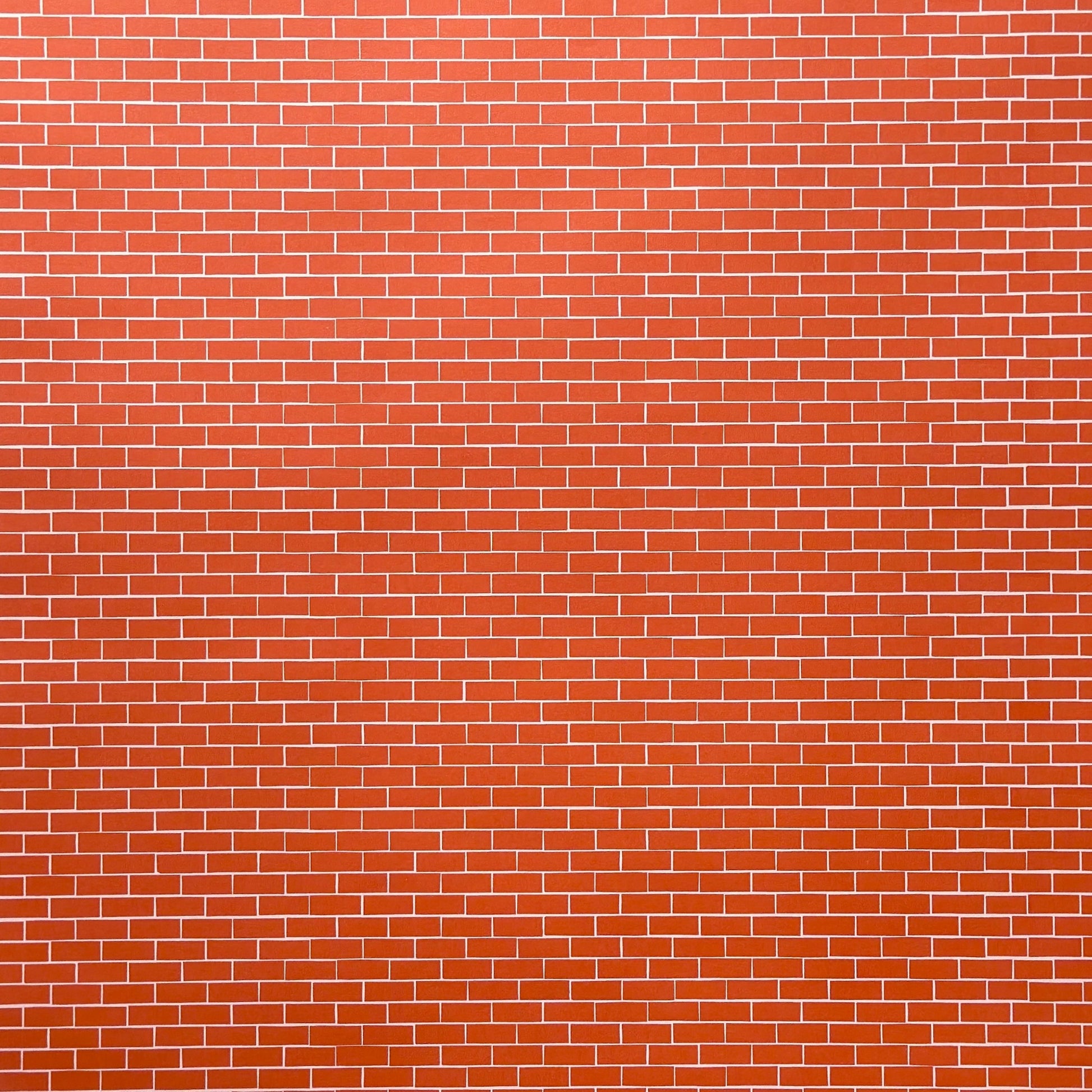 a sheet of gift wrap with a small brick design in rich red and pink