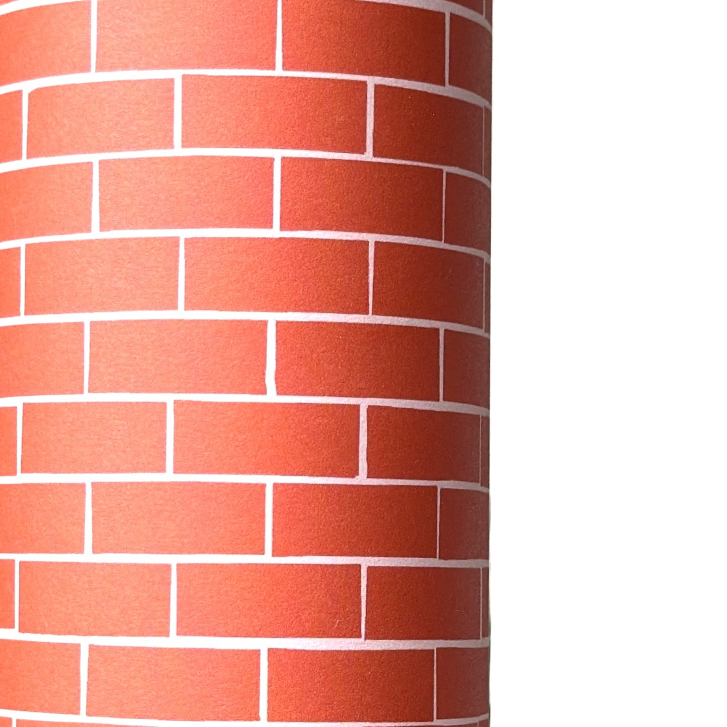 a sheet of gift wrap with a small brick design in rich red and pink