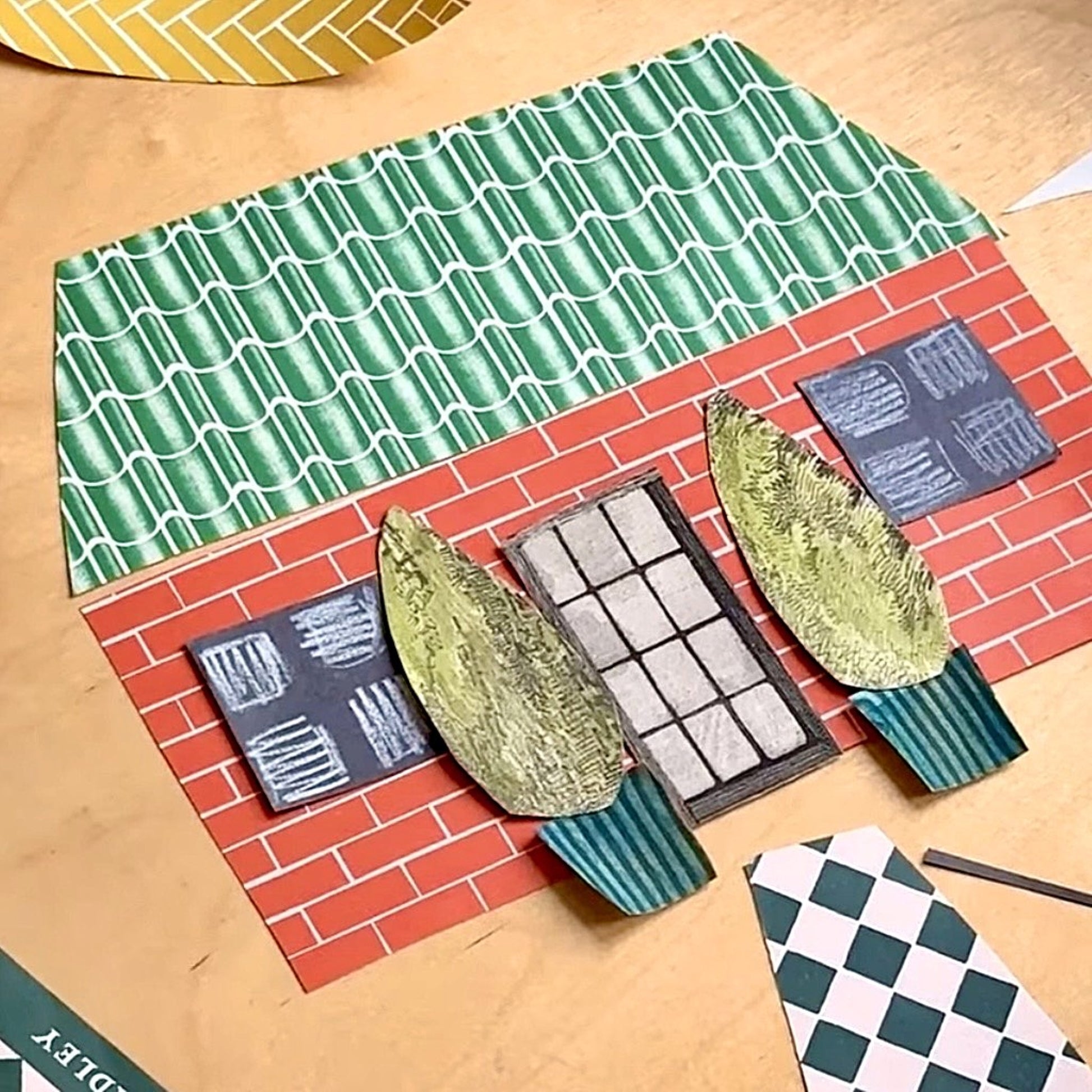 a collage of a house made with patterned gift wrap