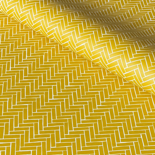 a sheet of wrapping paper with a parquet floor design in mustard and white