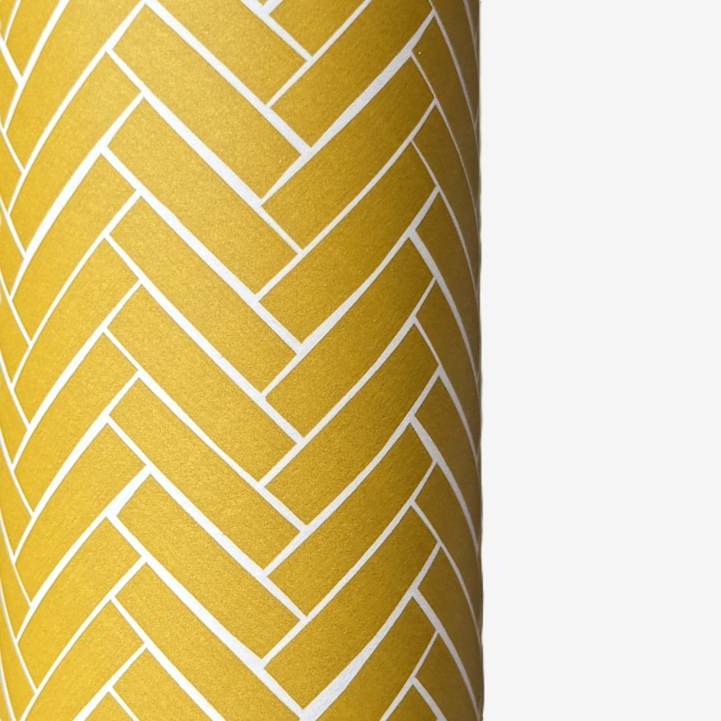 a sheet of wrapping paper with a parquet floor design in mustard and white