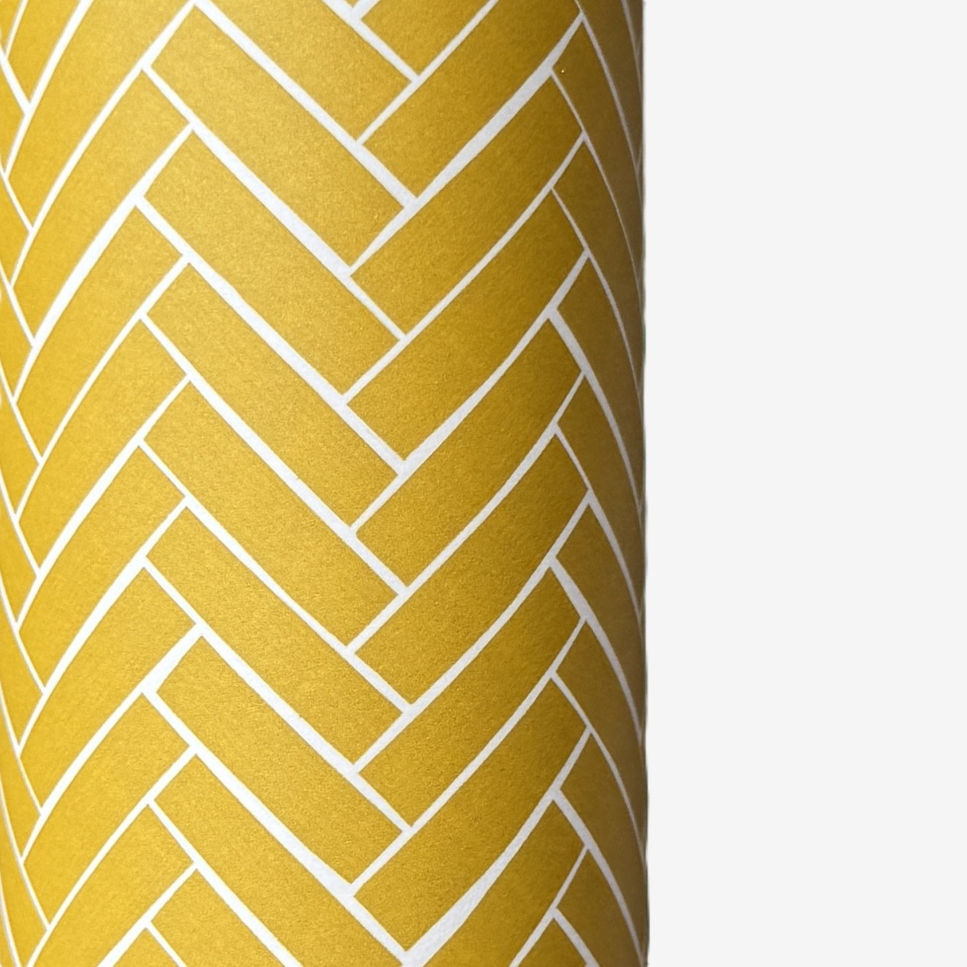 a sheet of wrapping paper with a parquet floor design in mustard and white