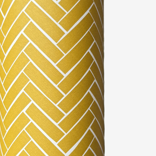 a sheet of wrapping paper with a parquet floor design in mustard and white