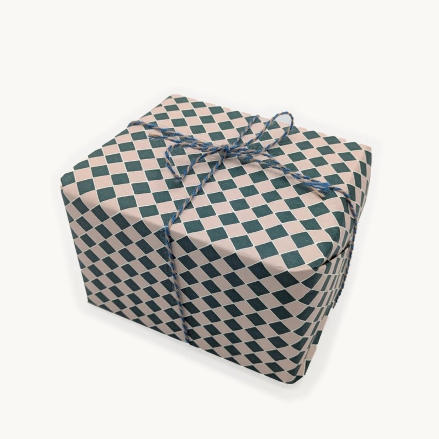 a sheet of wrapping paper with a quarry tile chequerboard design in very dark green and pale pink
