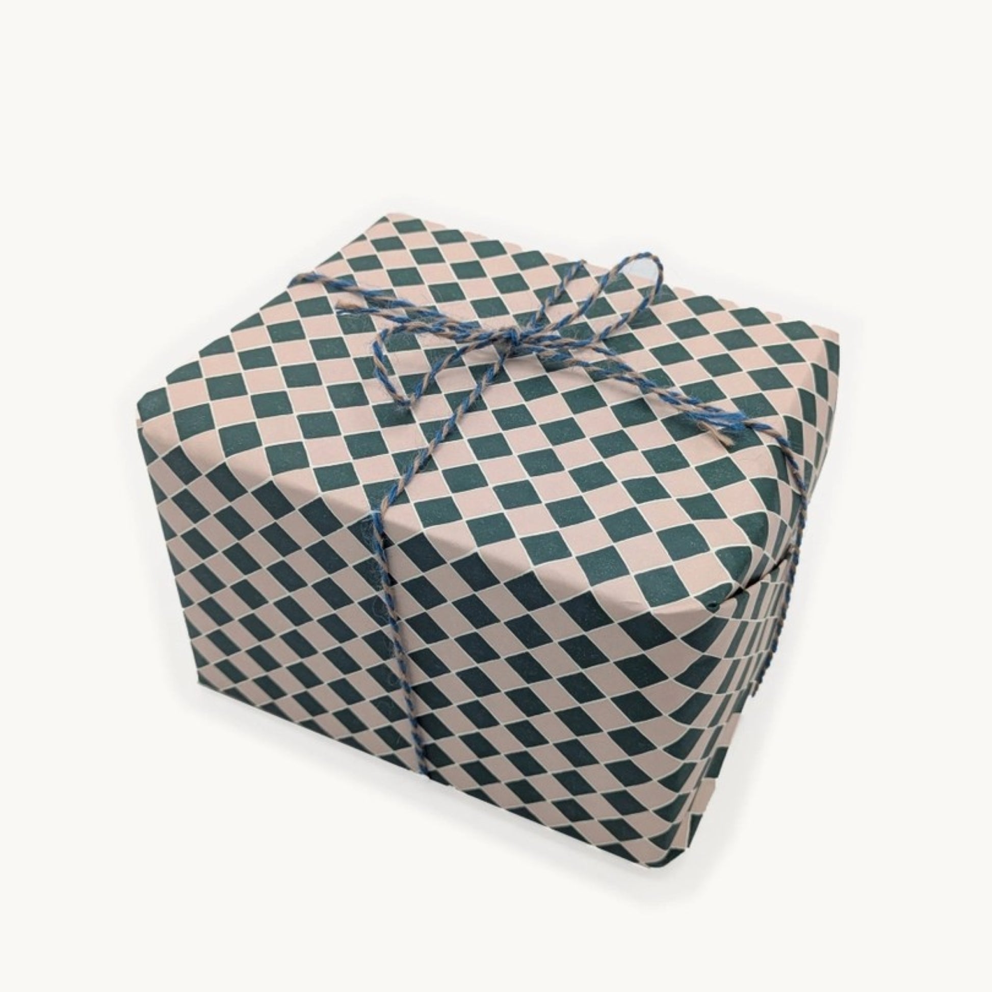 a sheet of wrapping paper with a quarry tile chequerboard design in very dark green and pale pink