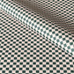 a sheet of wrapping paper with a quarry tile chequerboard design in very dark green and pale pink