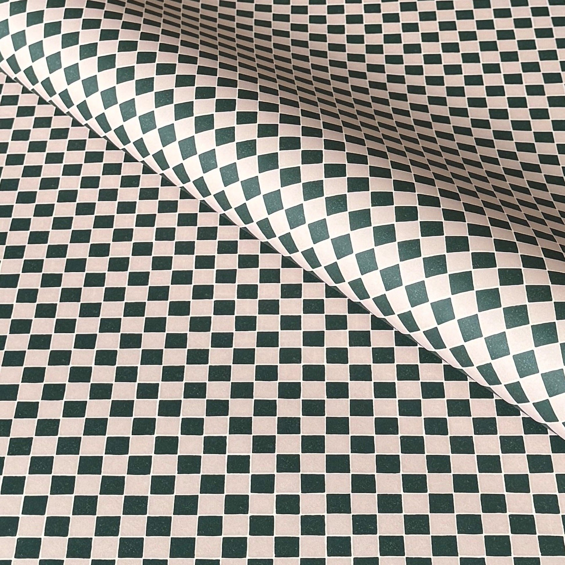 a sheet of wrapping paper with a quarry tile chequerboard design in very dark green and pale pink
