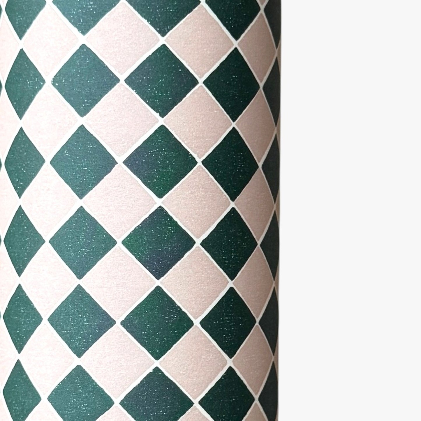 a sheet of wrapping paper with a quarry tile chequerboard design in very dark green and pale pink