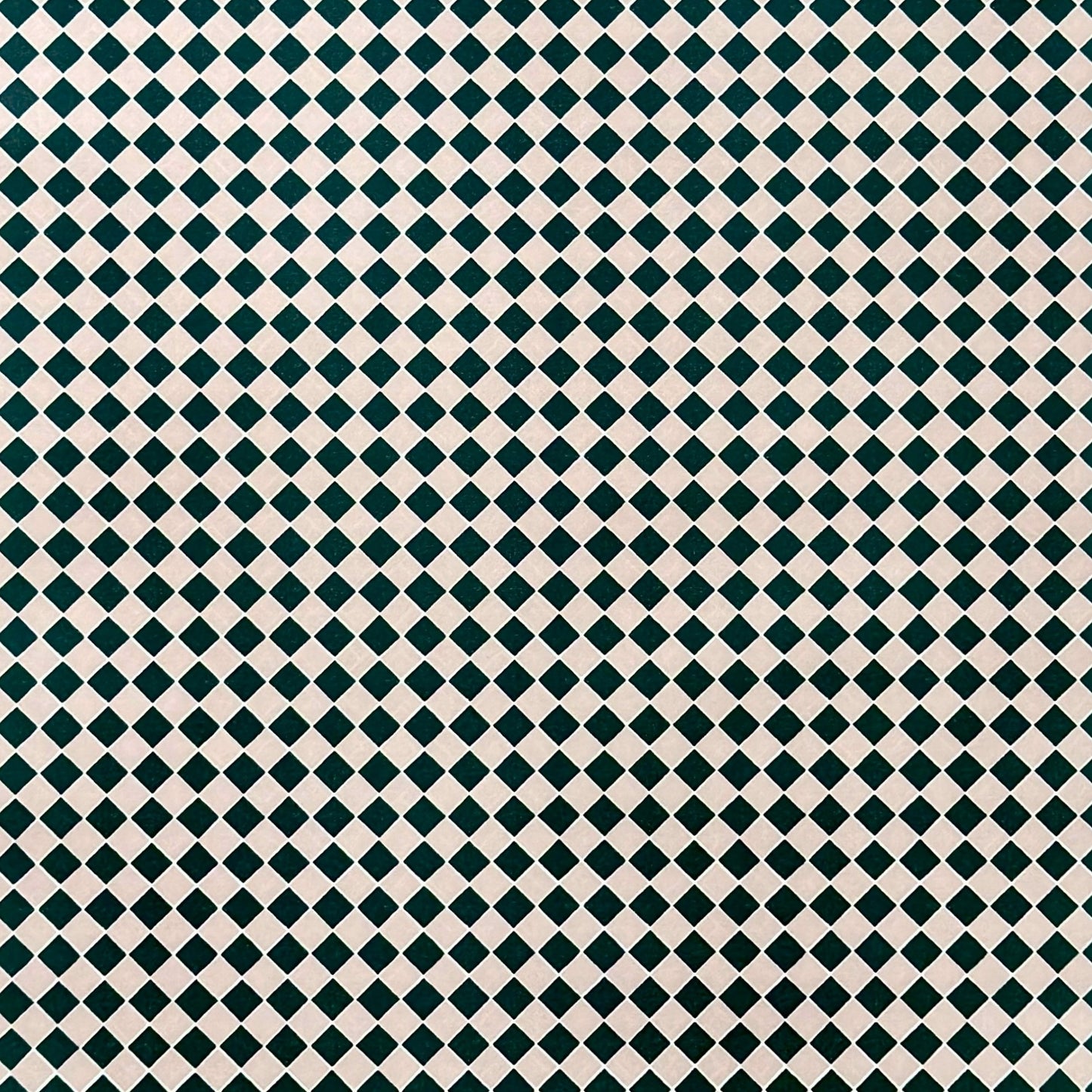 a sheet of wrapping paper with a quarry tile chequerboard design in very dark green and pale pink