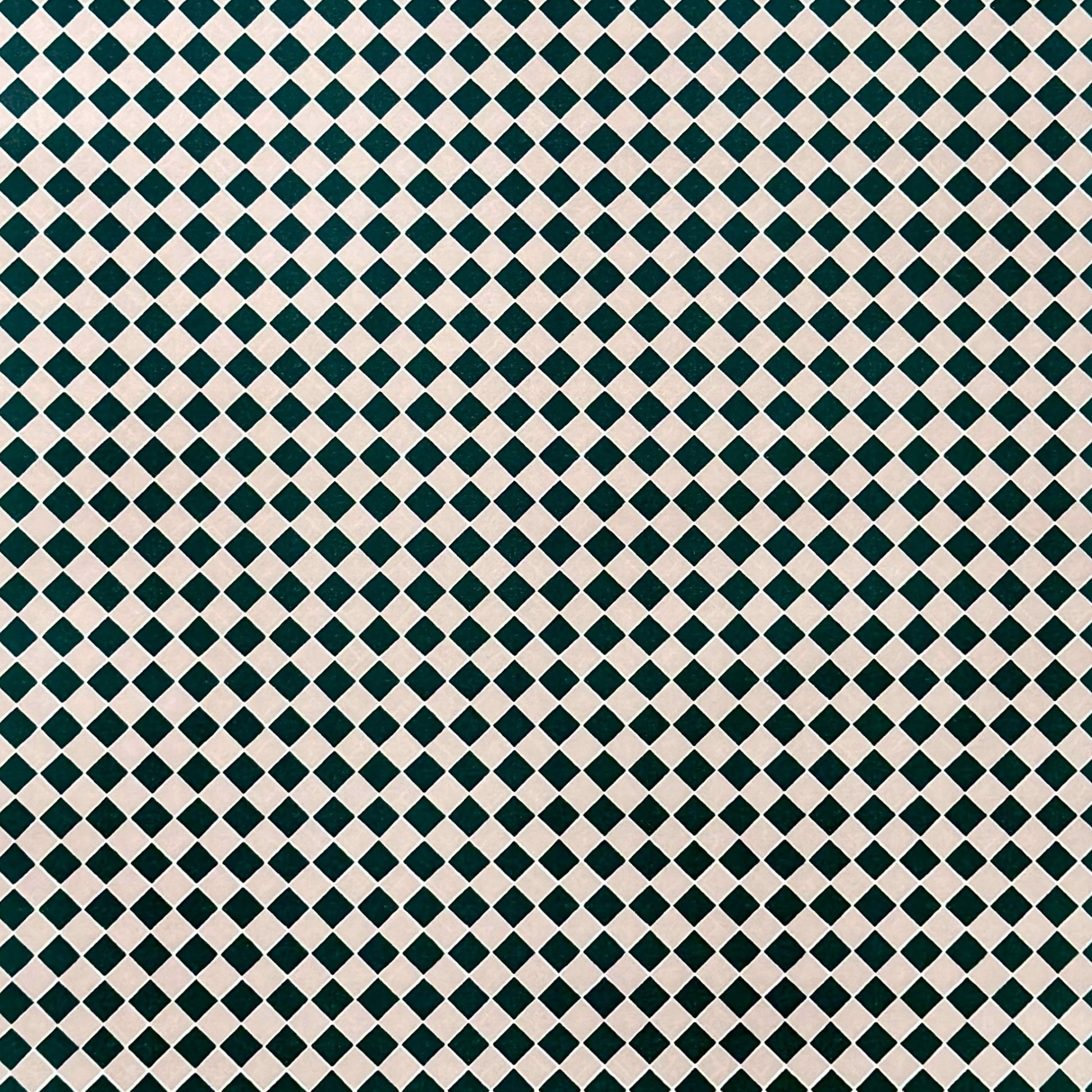 a sheet of wrapping paper with a quarry tile chequerboard design in very dark green and pale pink