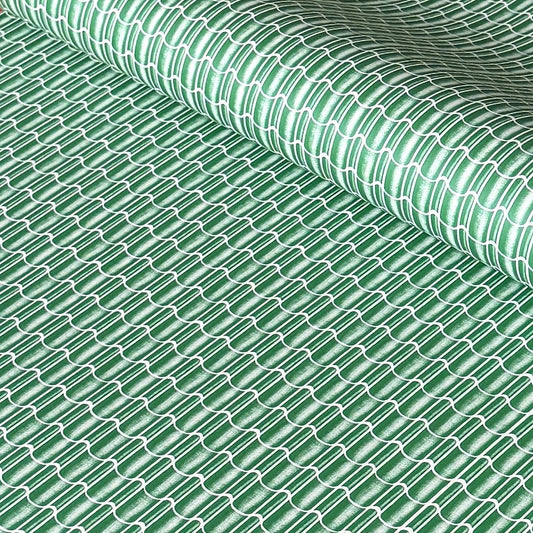 a sheet of wrapping paper with a pattern of green roof tiles