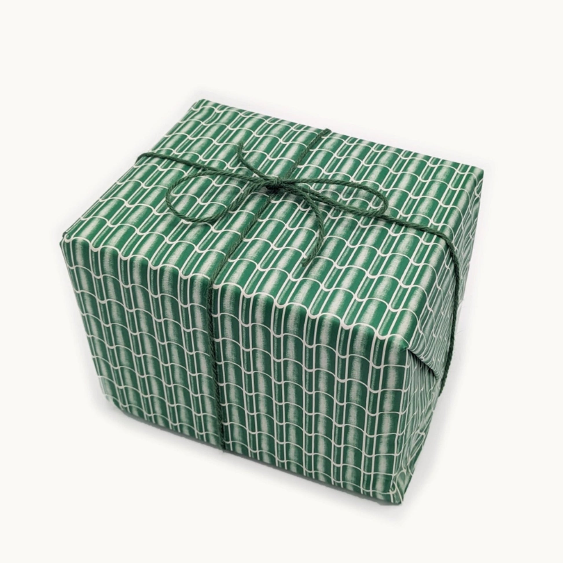 a sheet of wrapping paper with a pattern of green roof tiles