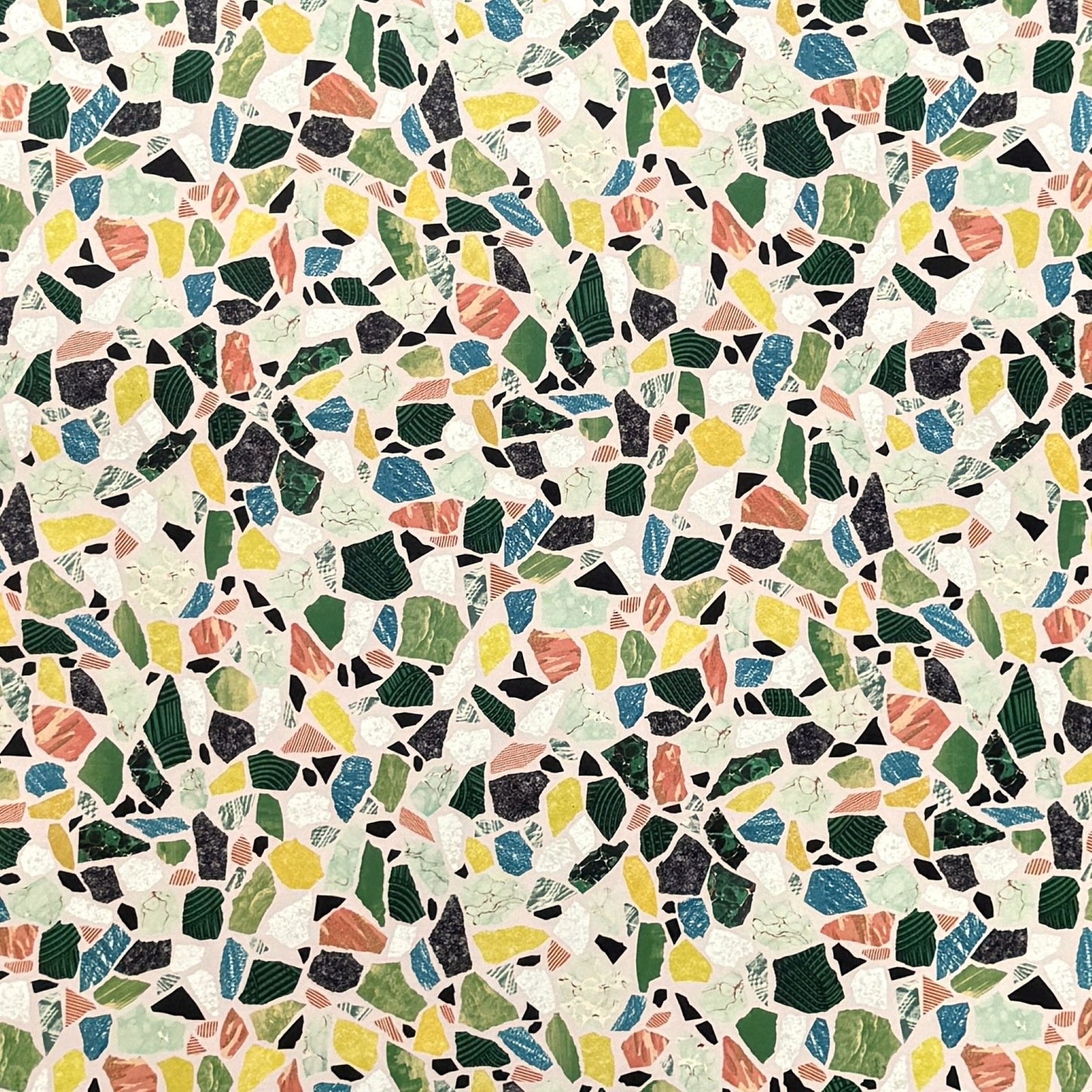 Colorful terrazzo pattern on a pale pink background. A sheet of wrapping paper