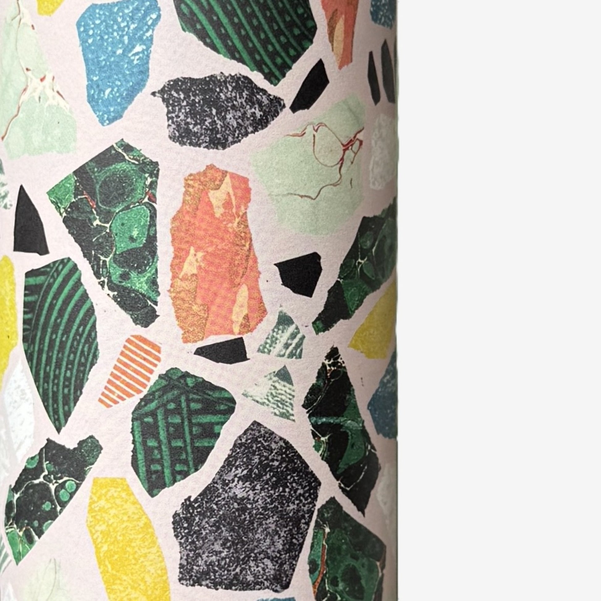 Colorful terrazzo pattern on a pale pink background. A sheet of wrapping paper