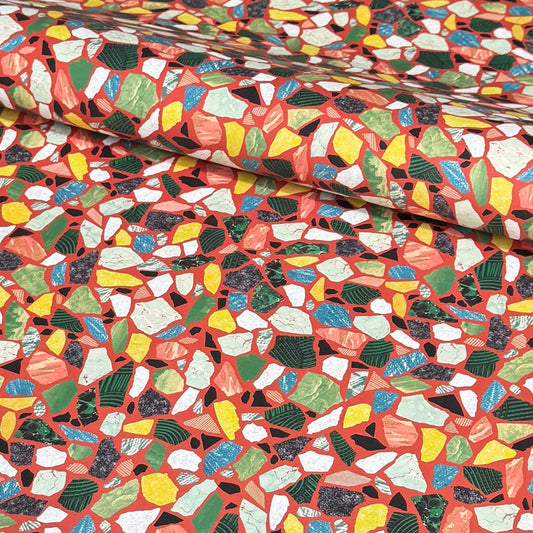 Colorful terrazzo pattern on a red background. A sheet of wrapping paper.