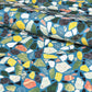 a sheet of wrapping paper with a teal blue background and terrazzo pattern