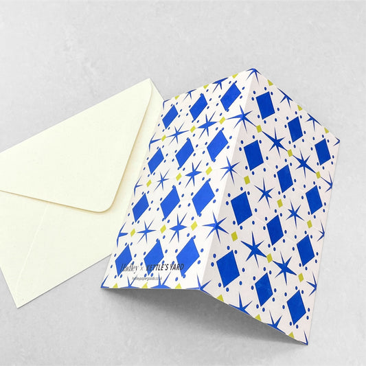 greetings card with cream background and blue and yellow papercut repeat pattern by Hadley Paper Goods