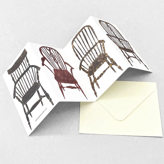 a concertina greeting card with four folds and drawings of four stick-back wooden chairs, by Hadley Paper Goods