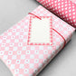 wrapping paper with pale pink and white diagonal checkerboard pattern by Heather Evelyn