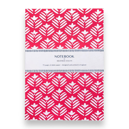 A5 notebook with magenta pink cover and repeat pattern of white flowers by Heather Evelyn