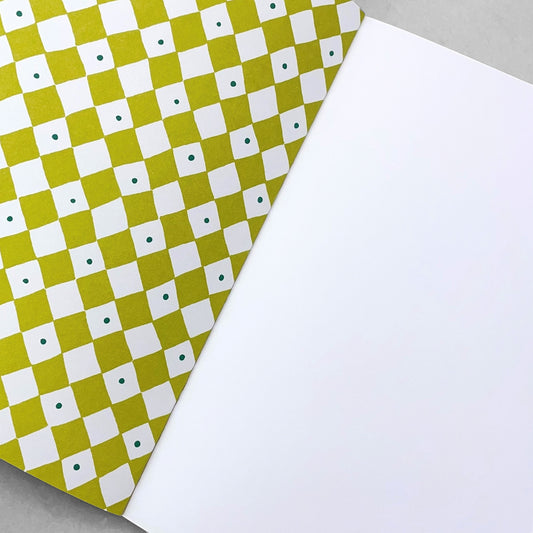 A5 notebook with a diagonal chequered pattern cover in lime green and white. by Heather Evelyn