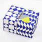 blue and white geometric wrapping paper by Hadley Paper Goods, wrapped as a present